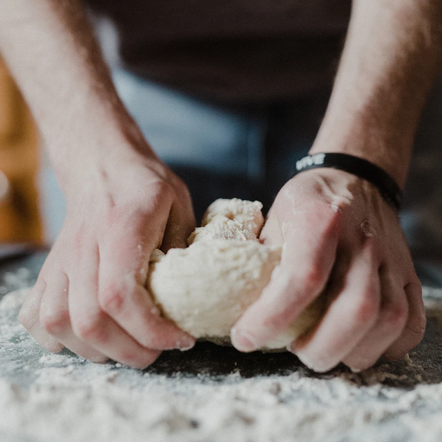 Hands holding a ball of dough