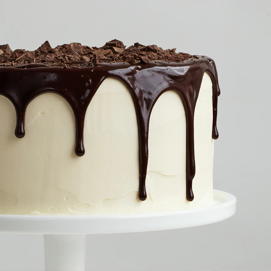 A white cake with chocolate drizzle